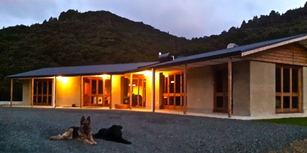 in the evening, our rammed earth home glows in the lights and looks so welcoming.